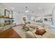 Bright living room featuring a stone fireplace, wood floors, and an open layout into the kitchen at 1741 Edgewater Dr, Mount Dora, FL 32757