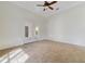 Well-lit room with a carpeted floor, wainscoting and french doors at 1741 Edgewater Dr, Mount Dora, FL 32757