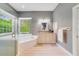 Elegant bathroom featuring a glass enclosed shower, garden tub, and a large window at 1741 Edgewater Dr, Mount Dora, FL 32757