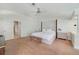 Large main bedroom with plush carpet, neutral tones, and a decorative ceiling fan at 1741 Edgewater Dr, Mount Dora, FL 32757