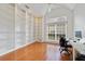 Office features built-in shelving, a large window and wood flooring at 1741 Edgewater Dr, Mount Dora, FL 32757