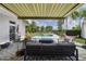 Covered patio with comfortable seating and great views of the lush landscape and pool at 1741 Edgewater Dr, Mount Dora, FL 32757