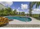 Resort-style pool and spa surrounded by lush landscaping, set against a picturesque view at 1741 Edgewater Dr, Mount Dora, FL 32757