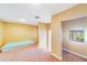 An empty room showing the plush carpet, paint color, window and an adjoining space at 1741 Edgewater Dr, Mount Dora, FL 32757