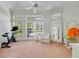 Bright sitting room with large windows, plush carpet, and views of the backyard and pool at 1741 Edgewater Dr, Mount Dora, FL 32757