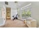 Bright sitting room with an exercise bike, lots of light and view to the outdoors at 1741 Edgewater Dr, Mount Dora, FL 32757