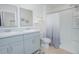 Clean bathroom with dual sinks, a framed mirror, and a glass-enclosed shower at 1785 Red Canyon Dr, Kissimmee, FL 34744