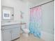 Charming bathroom with a vanity, toilet, and tub with a colorful mermaid-themed shower curtain at 1785 Red Canyon Dr, Kissimmee, FL 34744