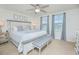 Serene bedroom with a large bed, neutral colors, and natural light from two windows at 1785 Red Canyon Dr, Kissimmee, FL 34744