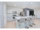 Bright kitchen with stainless steel appliances, an island with barstool seating, and white countertops at 1785 Red Canyon Dr, Kissimmee, FL 34744