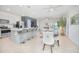 Open-concept living space with kitchen island, dining area, and living room, perfect for entertaining at 1785 Red Canyon Dr, Kissimmee, FL 34744