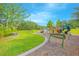 Playground with slides, climbing and picnic tables along walking path on grassy green space at 1785 Red Canyon Dr, Kissimmee, FL 34744