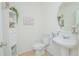 Charming powder room with pedestal sink, decorative mirror, and stylish accent decor at 1785 Red Canyon Dr, Kissimmee, FL 34744