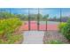 Community tennis court featuring secure fencing and well-maintained playing surface at 1785 Red Canyon Dr, Kissimmee, FL 34744