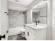 Bright bathroom featuring a shower-tub combo with sleek fixtures and modern tiling at 1850 North St, Longwood, FL 32750