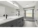 A modern bathroom showcasing a double vanity and walk-in shower at 1850 North St, Longwood, FL 32750