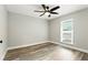 Bright bedroom featuring wood-look floors, a ceiling fan and a window letting in lots of natural light at 1850 North St, Longwood, FL 32750