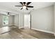 This bedroom features a ceiling fan and a closet with mirrored doors and ample natural light at 1850 North St, Longwood, FL 32750