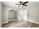 This bedroom features wood-look floors, a ceiling fan and a closet with mirrored doors at 1850 North St, Longwood, FL 32750