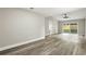 Bedroom with modern flooring, ceiling fan, ensuite bathroom, and sliding door at 1850 North St, Longwood, FL 32750