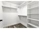 Walk-in closet featuring custom white shelving and hardwood floors at 1850 North St, Longwood, FL 32750