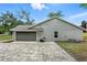 View of garage and gray brick driveway at 1850 North St, Longwood, FL 32750