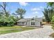 A beautifully landscaped yard accents this lovely single-story home at 1850 North St, Longwood, FL 32750