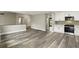 Open-concept living space with hardwood floors and an eat-in kitchen featuring stainless steel appliances at 1850 North St, Longwood, FL 32750