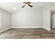 Bright, open living room with hardwood floors, a ceiling fan, and neutral walls at 1850 North St, Longwood, FL 32750
