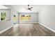 Bright, open living room featuring modern flooring, neutral walls, and sliding glass doors to the backyard at 1850 North St, Longwood, FL 32750