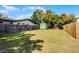 Spacious fenced backyard with green shed and grass, perfect for outdoor activities at 1911 Canton St, Orlando, FL 32803