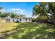 Lush backyard with ample green space and privacy provided by a wooden fence and mature trees at 1911 Canton St, Orlando, FL 32803