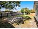Spacious fenced backyard with mature trees, lawn and concrete slab area at 1911 Canton St, Orlando, FL 32803