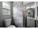 Well-lit bathroom featuring a modern toilet and beautiful gray and white tiled shower at 1911 Canton St, Orlando, FL 32803