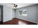 A comfortable bedroom with hardwood floors, ceiling fan, and a window, creating a tranquil personal space at 1911 Canton St, Orlando, FL 32803