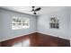 Bedroom with hardwood floors, ceiling fan, and two windows with beautiful views, offering a peaceful retreat at 1911 Canton St, Orlando, FL 32803