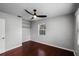 Bedroom features hardwood floors, a ceiling fan, and a closet with storage, creating a comfortable living space at 1911 Canton St, Orlando, FL 32803