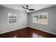 Bright bedroom with hardwood floors, ceiling fan, and dual windows allowing for abundant natural light at 1911 Canton St, Orlando, FL 32803