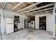 Spacious garage featuring a utility area with a washer, dryer, fridge, and extra storage, offering practical convenience at 1911 Canton St, Orlando, FL 32803