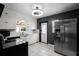 Kitchen features white cabinets, stainless steel refrigerator, and modern lighting at 1911 Canton St, Orlando, FL 32803