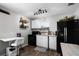 Bright kitchen featuring white cabinets and black appliances, perfect for cooking at 1911 Canton St, Orlando, FL 32803