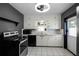 Traditional kitchen features white cabinets, tile backsplash, and stainless steel appliances at 1911 Canton St, Orlando, FL 32803