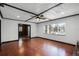 Living room with hardwood floors, ceiling fan, and natural light through a large window at 1911 Canton St, Orlando, FL 32803