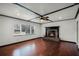 Cozy living room with hardwood floors and a stone fireplace with mantle at 1911 Canton St, Orlando, FL 32803