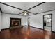 Cozy living room with hardwood floors and a stone fireplace with mantle at 1911 Canton St, Orlando, FL 32803