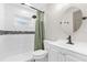 Bathroom includes shower with decorative tile, updated vanity, and shower curtain at 2098 Heathwood St, Deltona, FL 32725