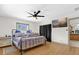 Bright bedroom featuring a ceiling fan, TV, and natural light at 2098 Heathwood St, Deltona, FL 32725