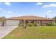 Charming single-story brick home featuring a well-maintained lawn and beautiful landscaping at 2098 Heathwood St, Deltona, FL 32725