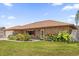 Lovely brick home with a manicured front lawn and colorful garden beds, creating inviting curb appeal at 2098 Heathwood St, Deltona, FL 32725