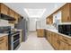 Well-lit kitchen with light wood cabinets, stainless steel appliances, and a skylight at 2098 Heathwood St, Deltona, FL 32725